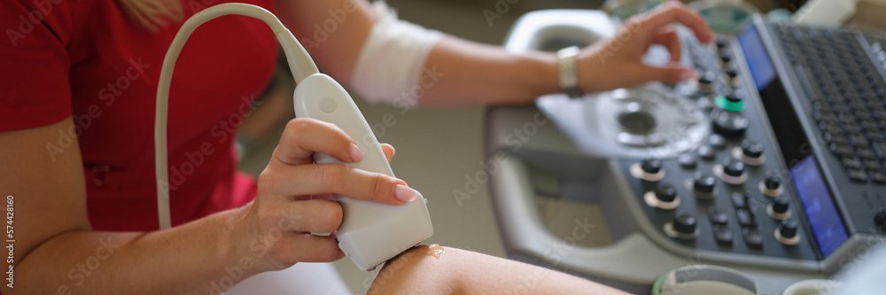 Ultrasound probe on skin preparing for exam.